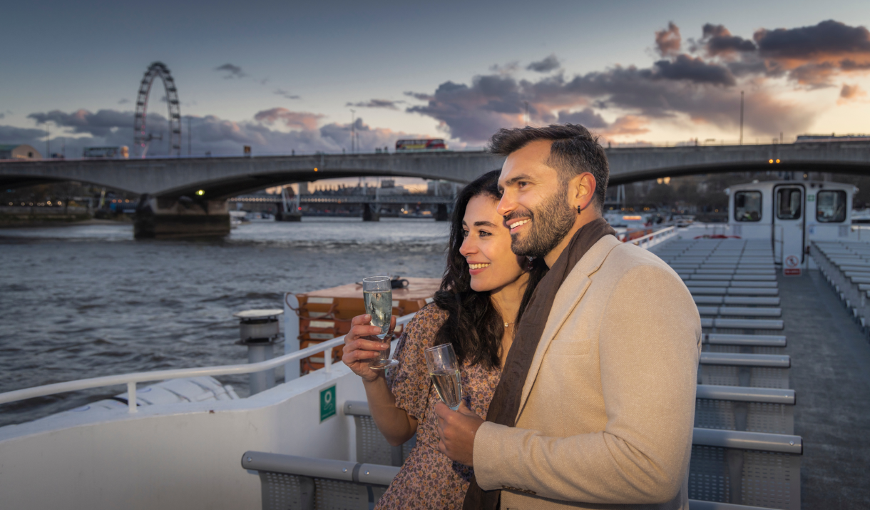 A couple admire the London view on Valentine's Day from upper deck on City Cruises